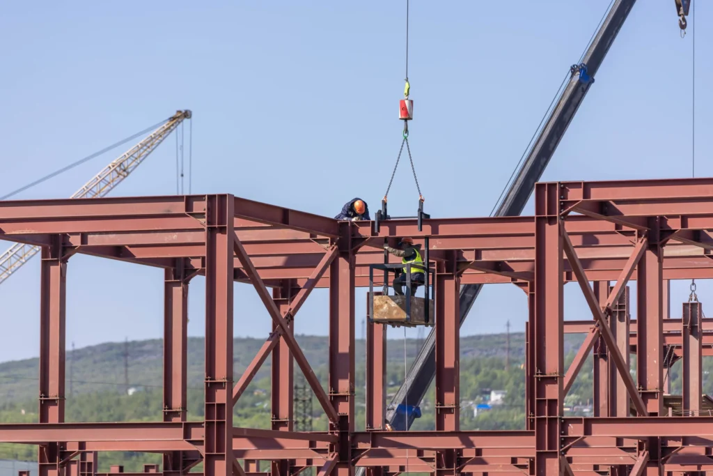 Red structural steel frame on a London construction site